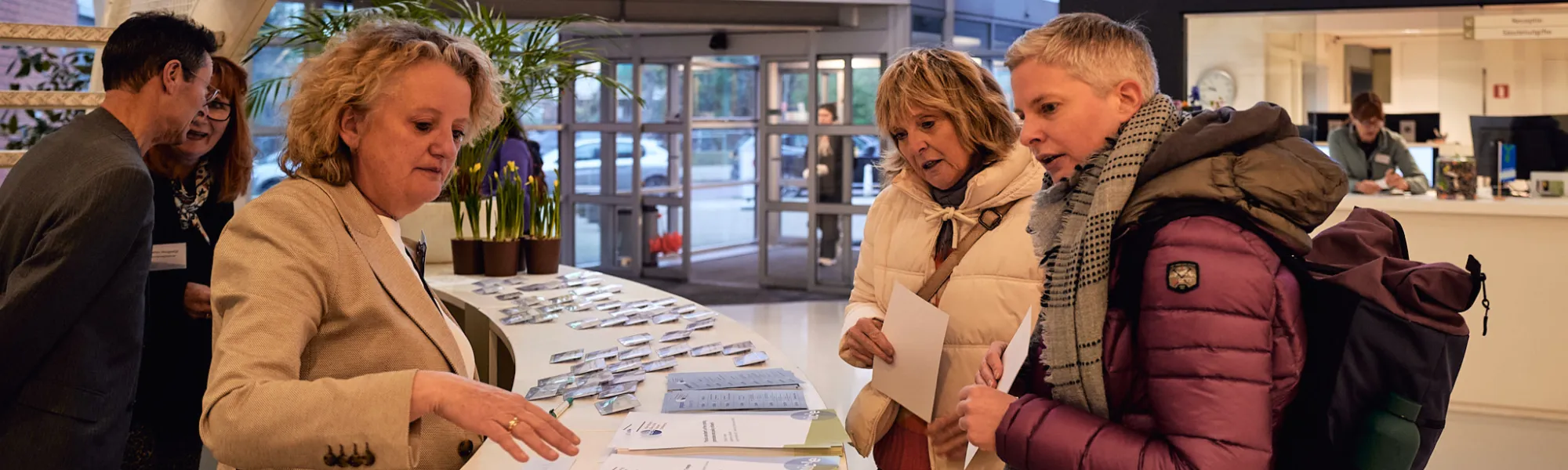 header ibtc: people at the counter IBTC in Domstad Utrecht